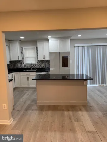 a white toilet sitting next to a bath tub