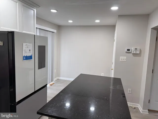 a view of kitchen with stainless steel appliances granite countertop a stove a sink and a microwave