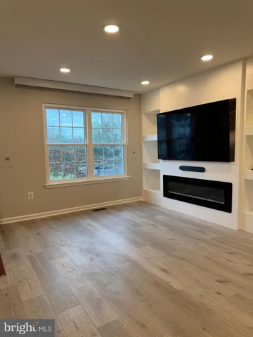 a kitchen with granite countertop a stove a sink and a microwave