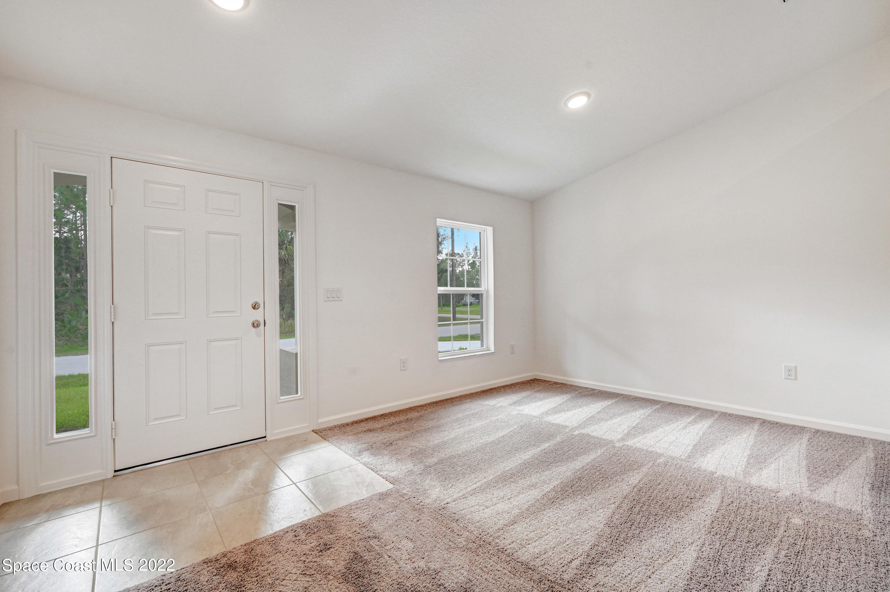 561 Scenic Road Palm Bay, FL 32908 - Photo 13 of 40 a view of an empty room with a window