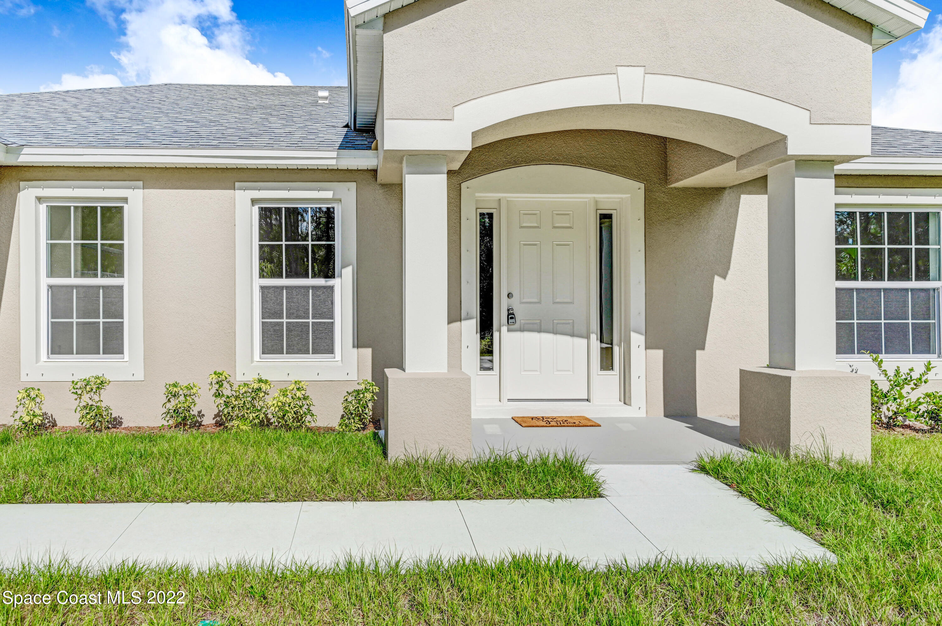 561 Scenic Road Palm Bay, FL 32908 - Photo 2 of 40 a front view of a house with a yard