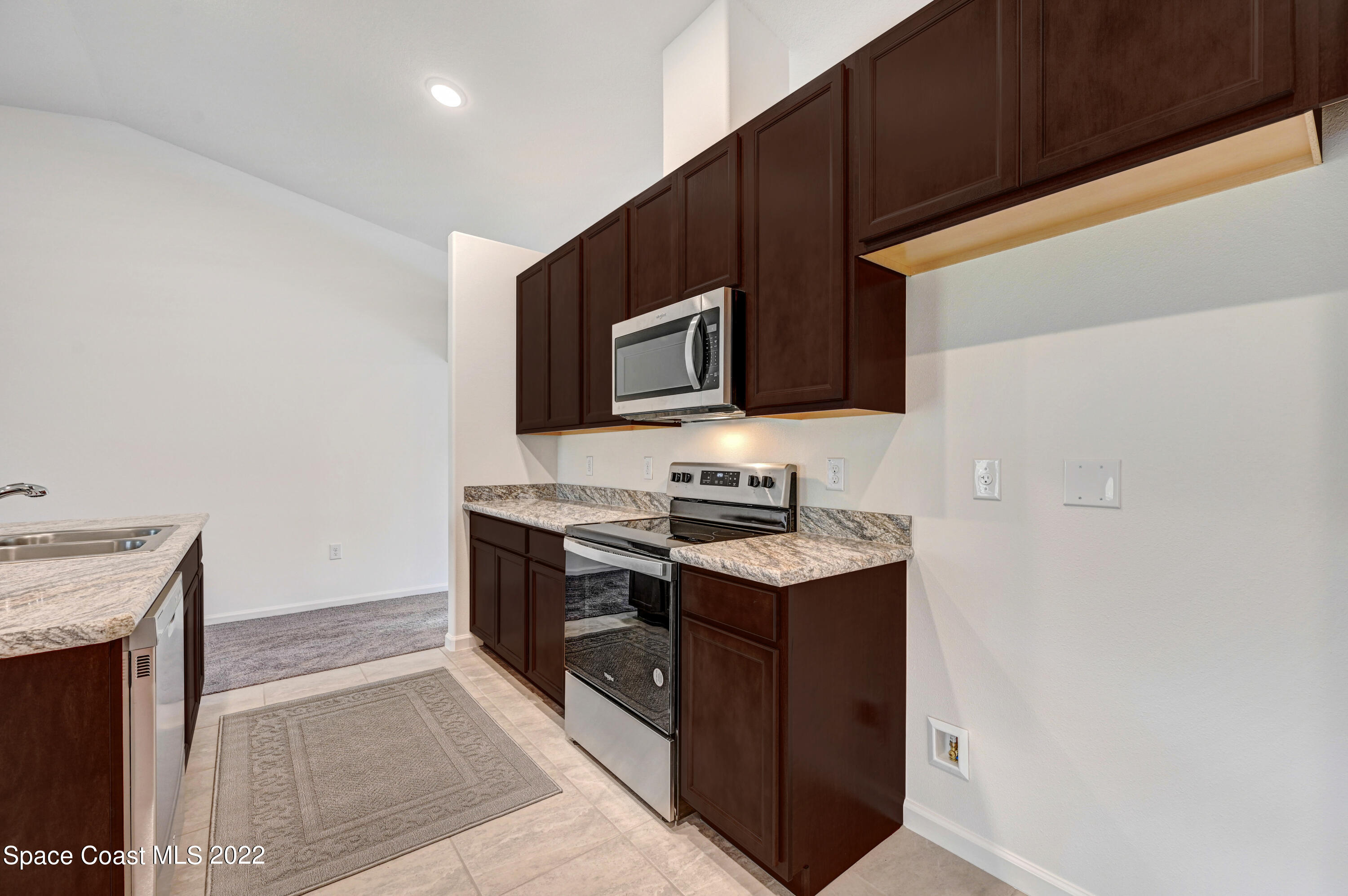 561 Scenic Road Palm Bay, FL 32908 - Photo 21 of 40 a kitchen with stainless steel appliances a stove microwave and refrigerator