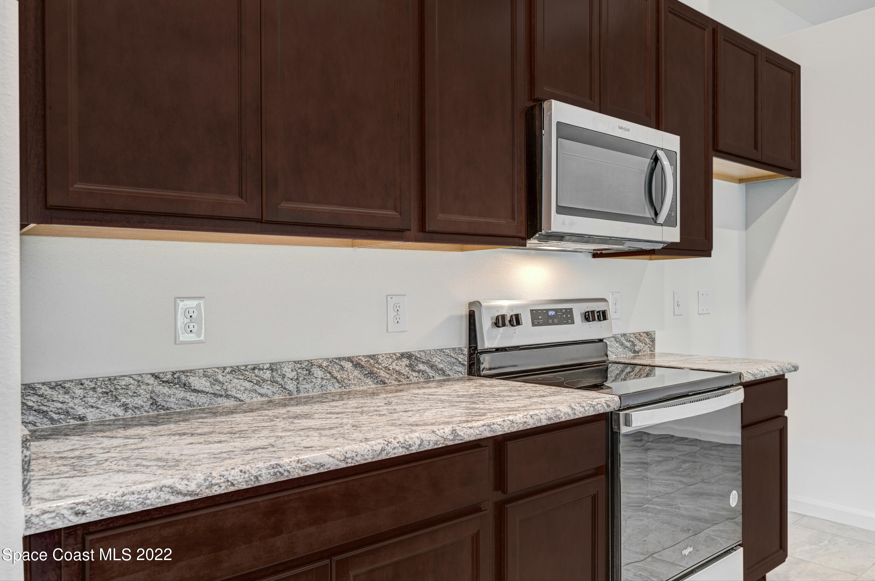 561 Scenic Road Palm Bay, FL 32908 - Photo 22 of 40 a kitchen with granite countertop cabinets stainless steel appliances and a sink