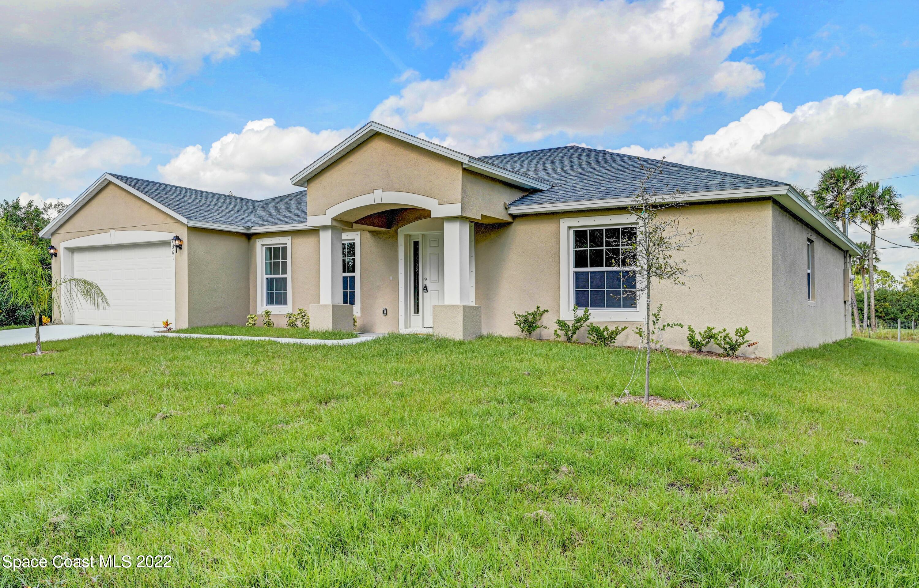 561 Scenic Road Palm Bay, FL 32908 - Photo 3 of 40 a view of a house with backyard and garden