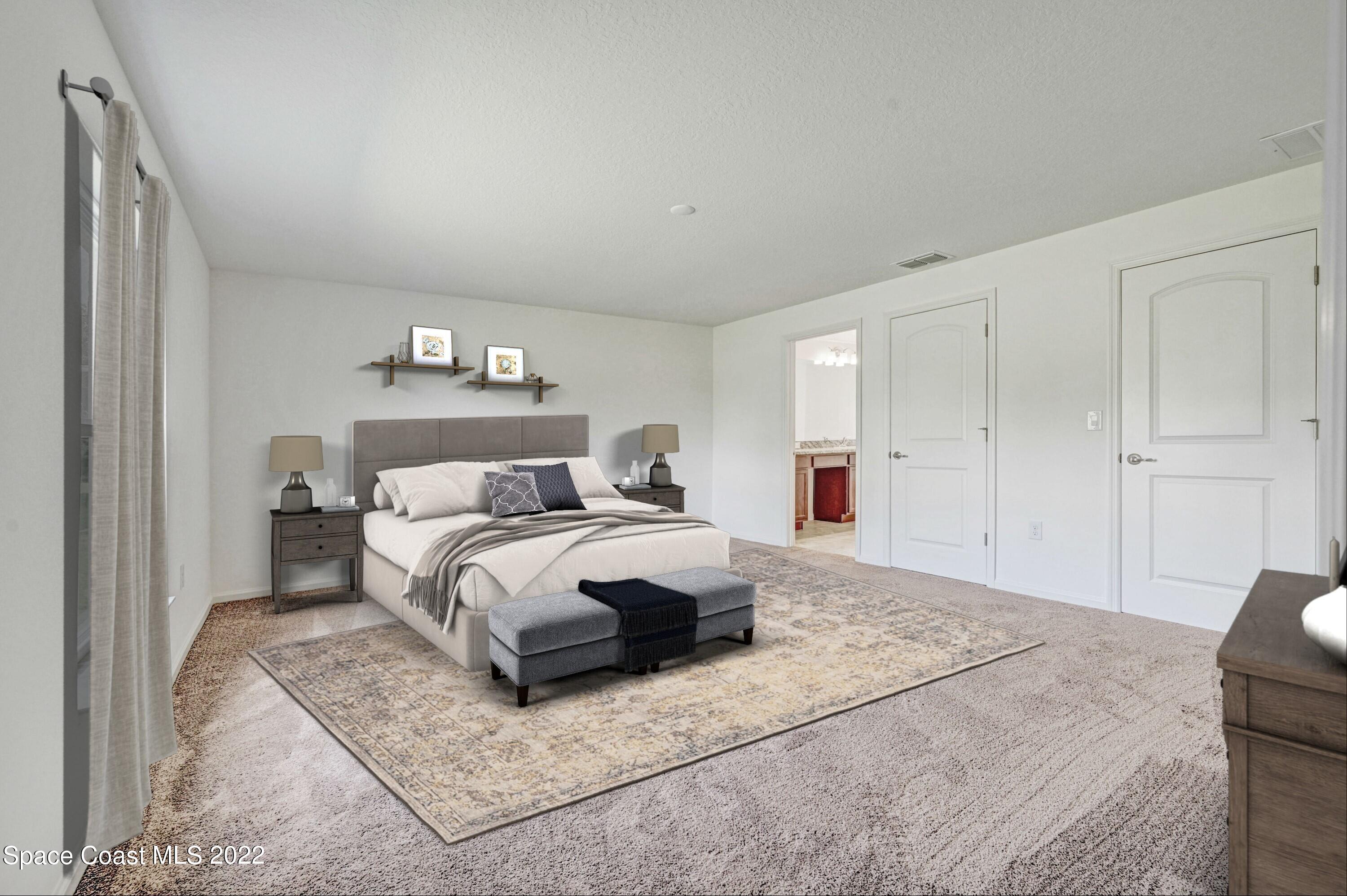 561 Scenic Road Palm Bay, FL 32908 - Photo 31 of 40 a bedroom with a bed and a night stand