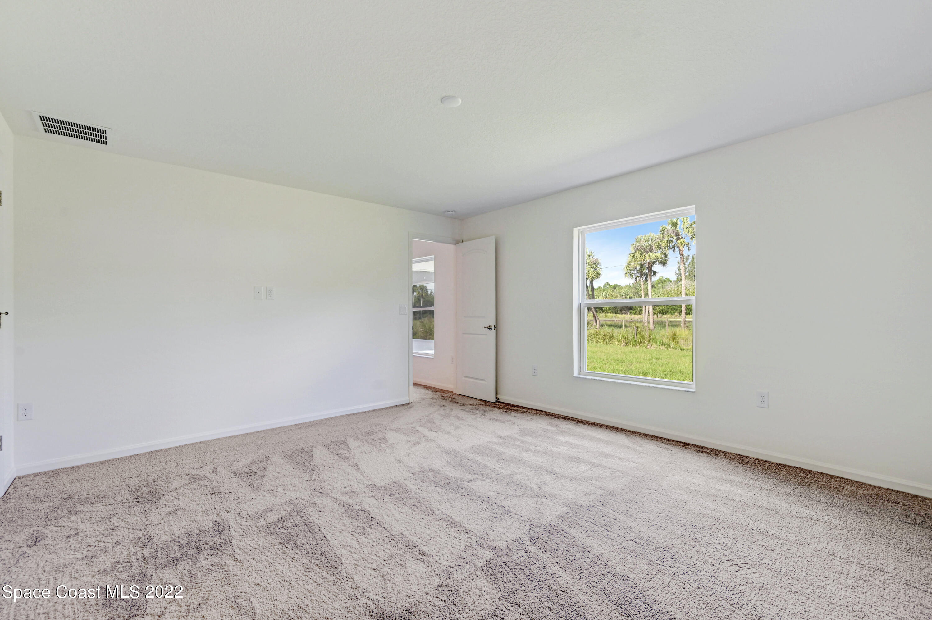 561 Scenic Road Palm Bay, FL 32908 - Photo 33 of 40 an empty room with windows