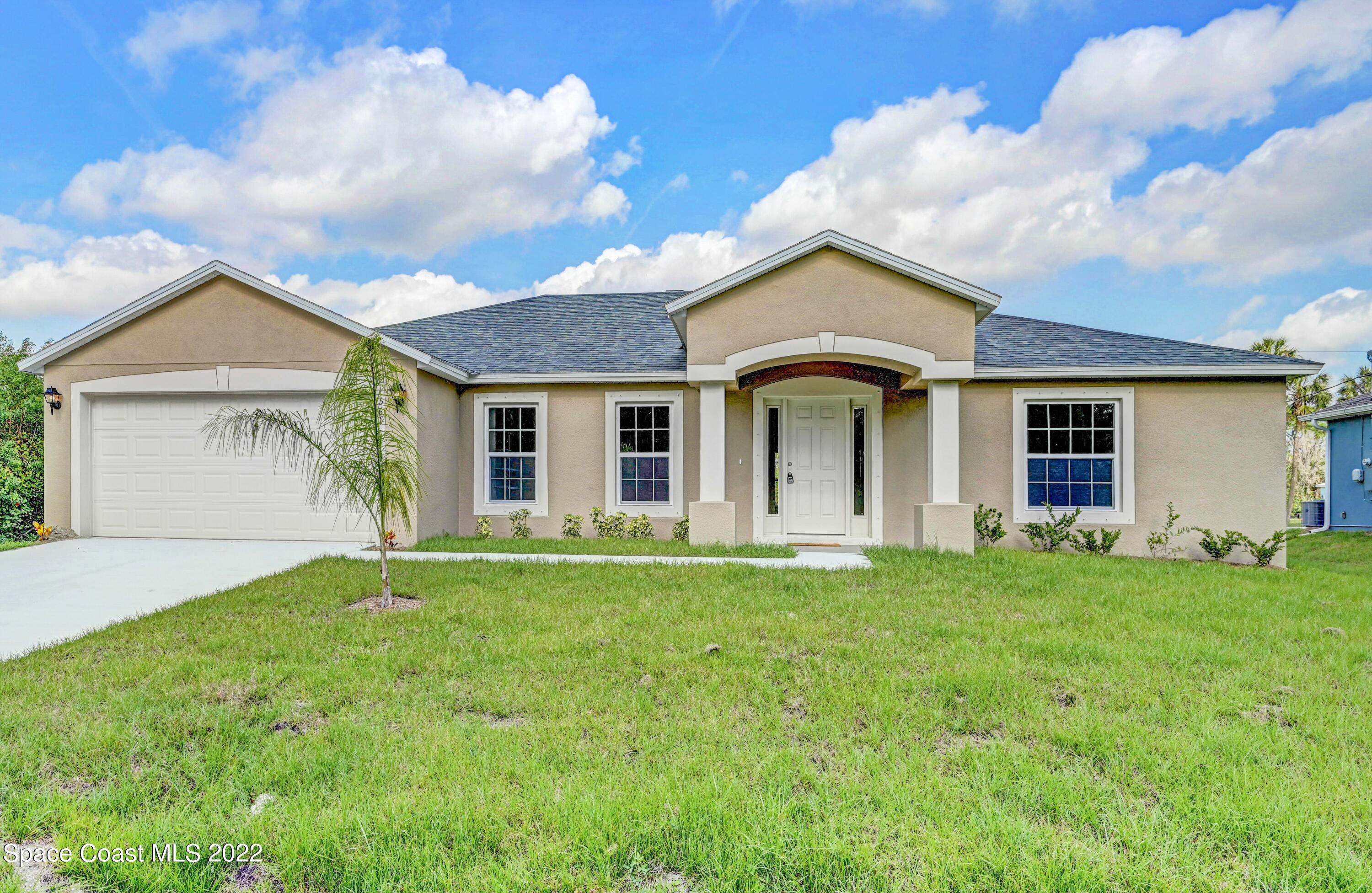 561 Scenic Road Palm Bay, FL 32908 - Photo 4 of 40 front view of a house and a yard