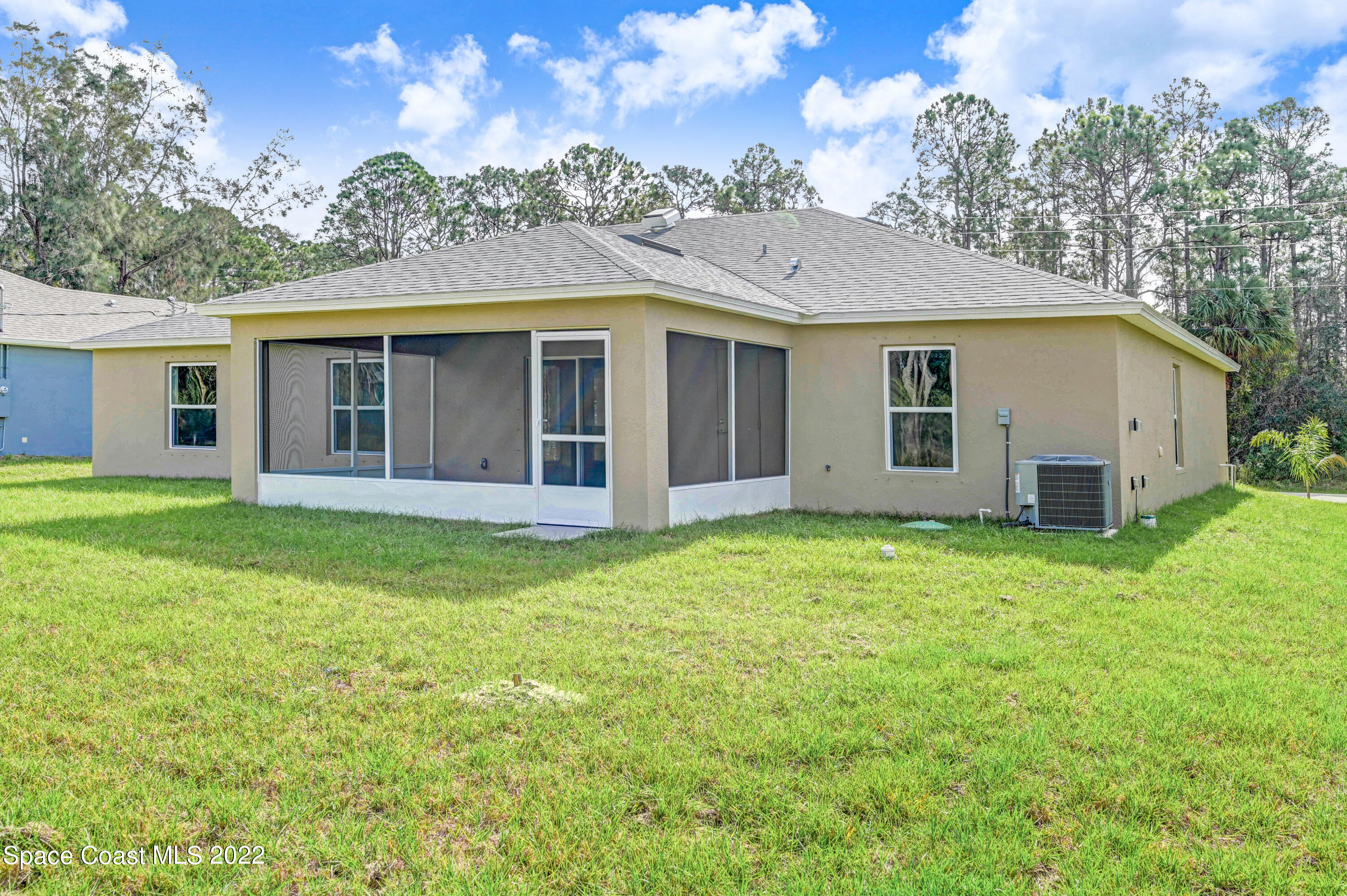 561 Scenic Road Palm Bay, FL 32908 - Photo 7 of 40 a view of a house with a backyard