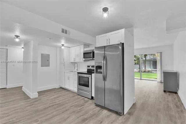 a kitchen with stainless steel appliances a refrigerator and a stove top oven