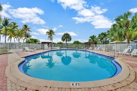 a view of a swimming pool with a yard