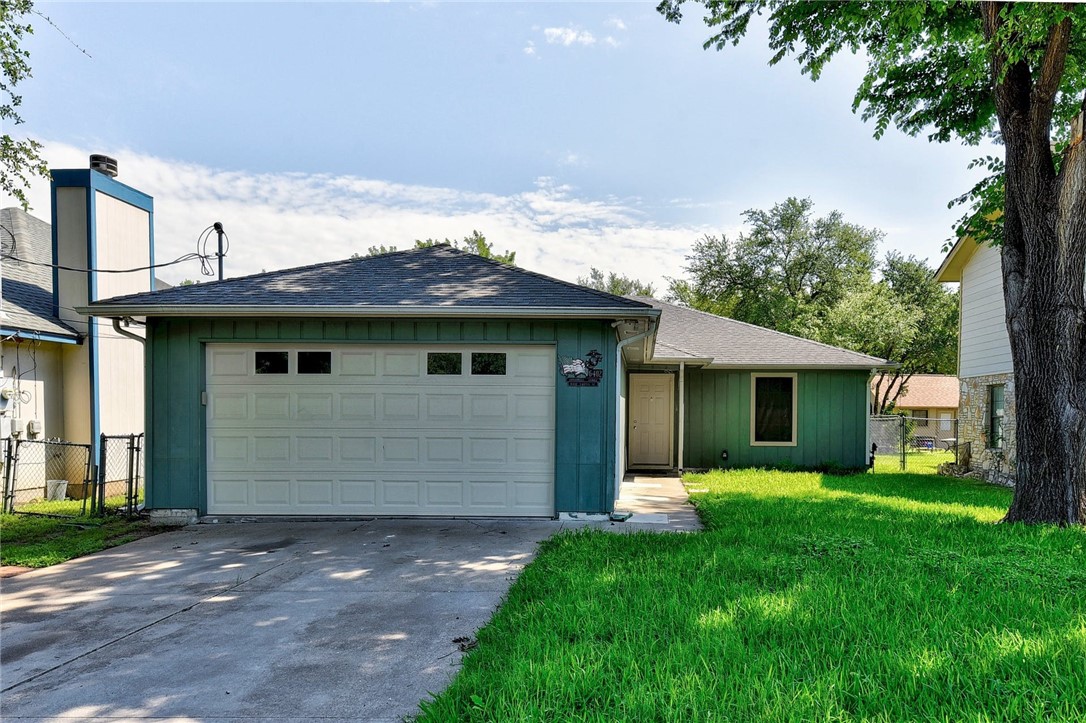 6402 Santos Street Austin, TX 78741 - Photo 1 of 22 a view of a house with yard and a garden