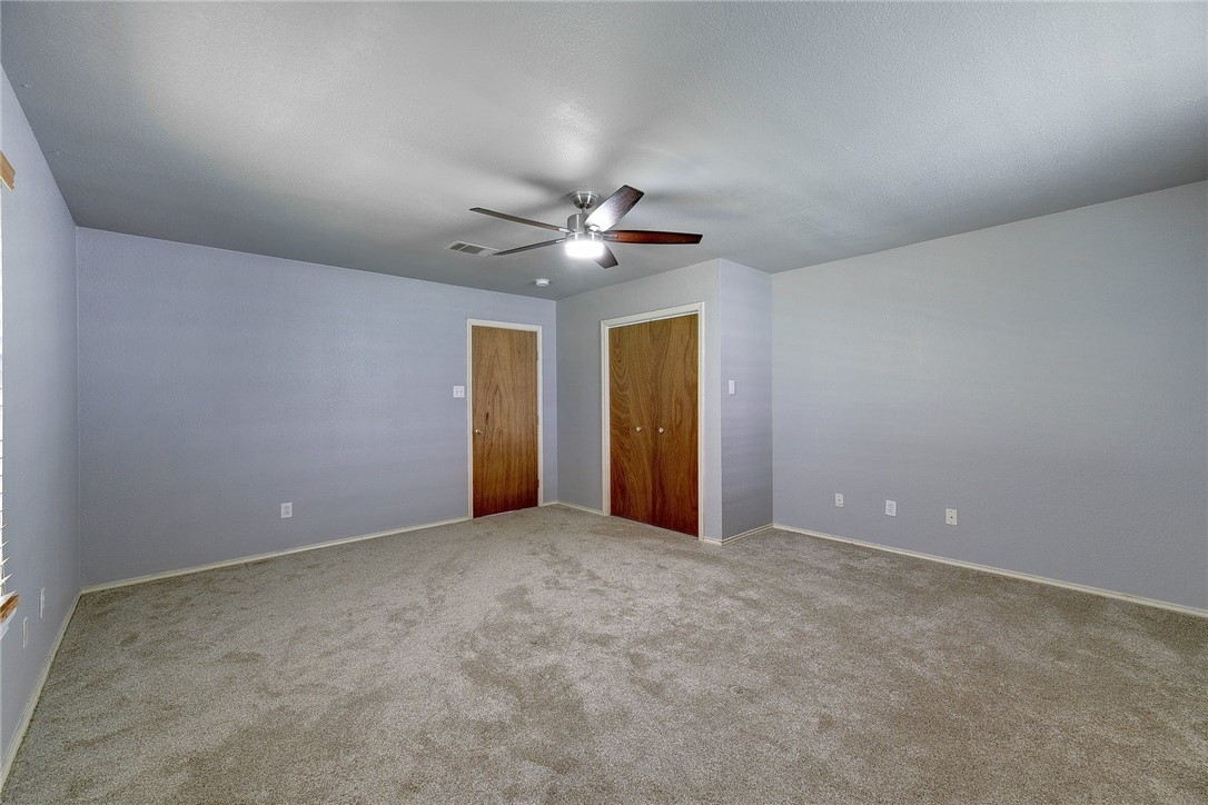 6402 Santos Street Austin, TX 78741 - Photo 14 of 22 an empty room with a ceiling fan and a window