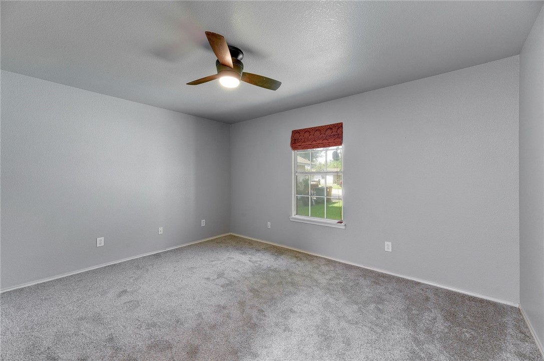 6402 Santos Street Austin, TX 78741 - Photo 17 of 22 an empty room with windows and fan