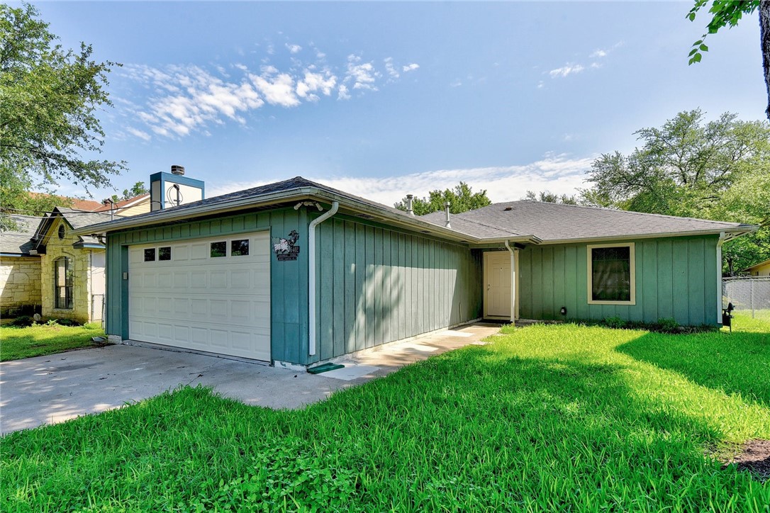 6402 Santos Street Austin, TX 78741 - Photo 2 of 22 a view of a house with a yard