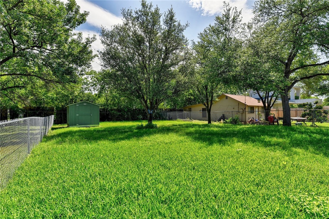 6402 Santos Street Austin, TX 78741 - Photo 21 of 22 a view of a house with backyard and a tree