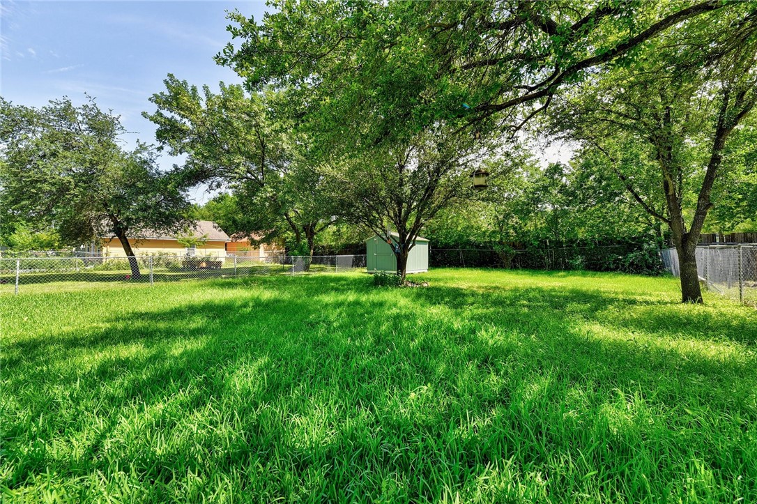 6402 Santos Street Austin, TX 78741 - Photo 6 of 22 a view of green field with trees in the background