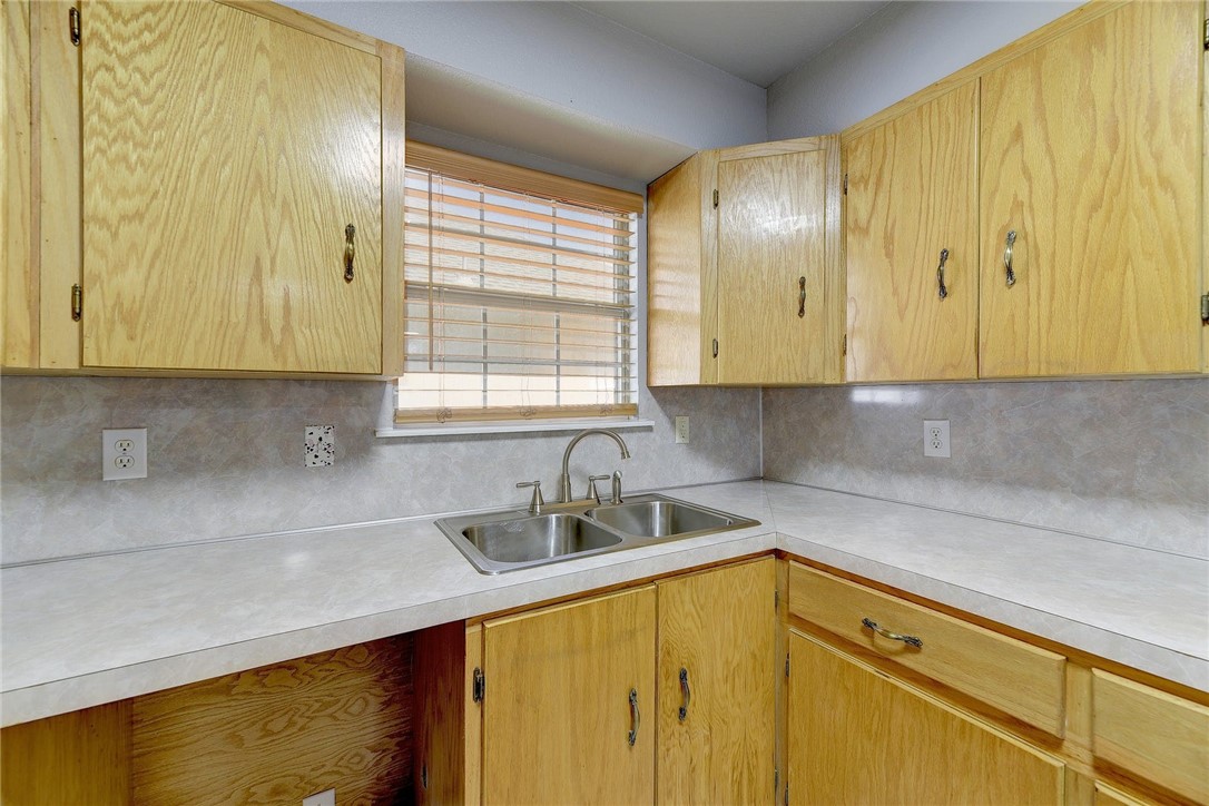 6402 Santos Street Austin, TX 78741 - Photo 10 of 22 a kitchen with a sink and cabinets