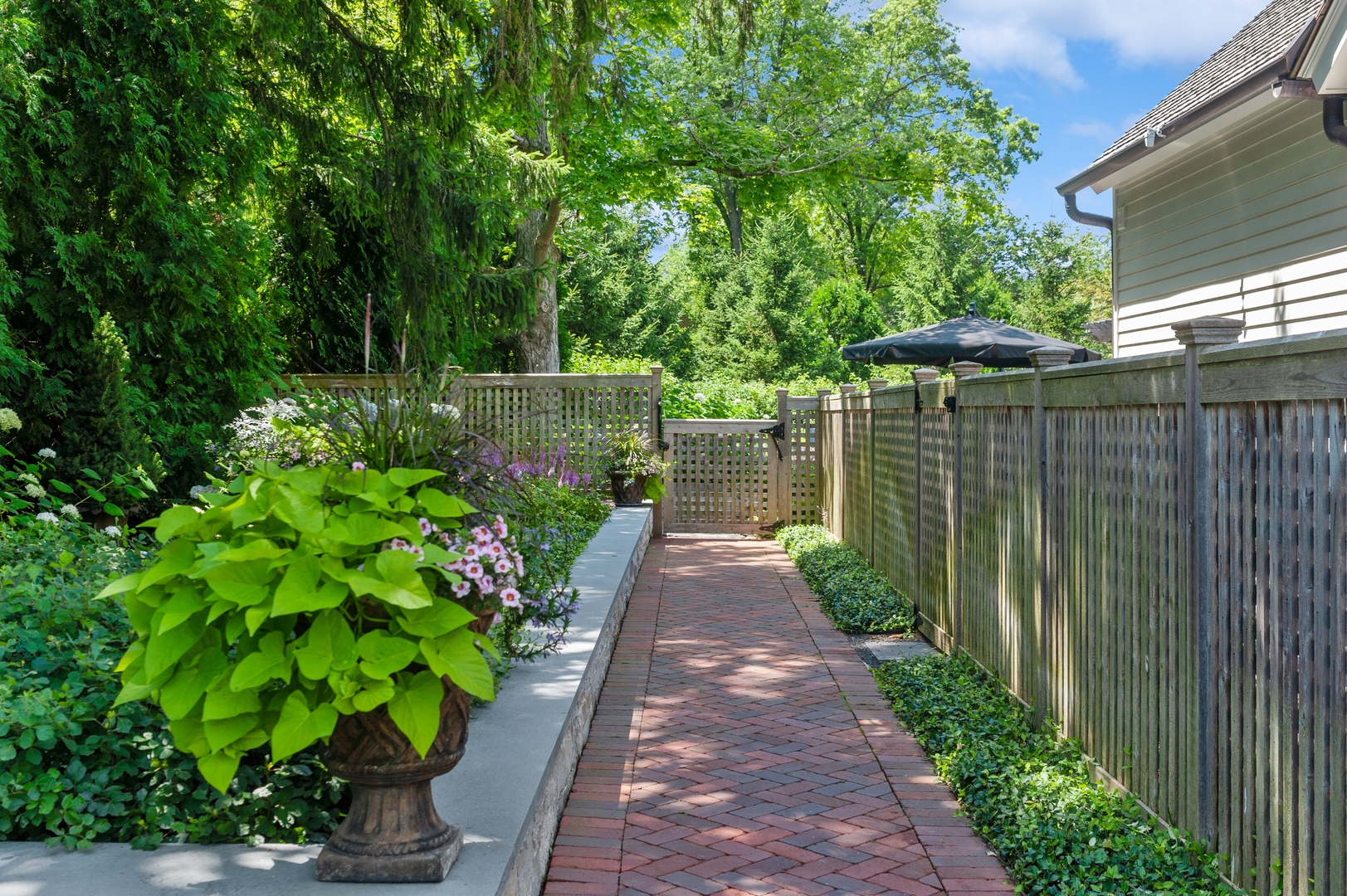 1120 Elm Tree Road Lake Forest, IL 60045 - Photo 2 of 10 a view of a backyard with potted plants and large trees