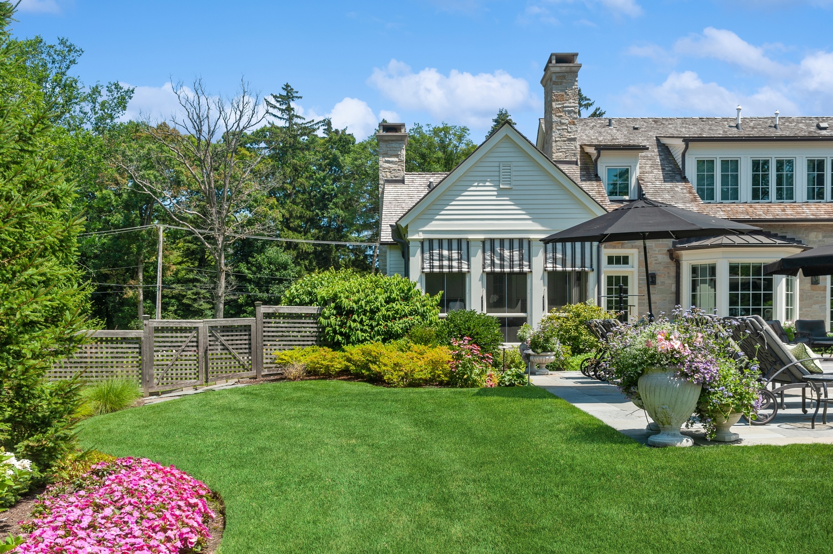 1120 Elm Tree Road Lake Forest, IL 60045 - Photo 5 of 10 a front view of a house with a yard and potted plants
