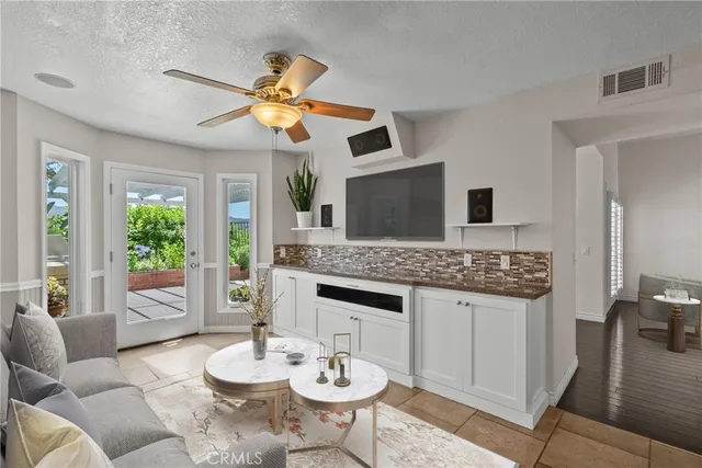 a view of a livingroom with furniture and a kitchen