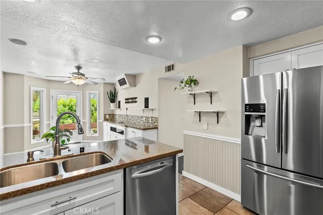 a kitchen with a refrigerator and a sink