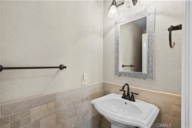 a bathroom with a sink a shower and a mirror
