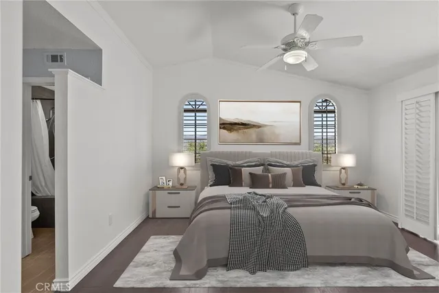 a bedroom with a large bed and a chandelier