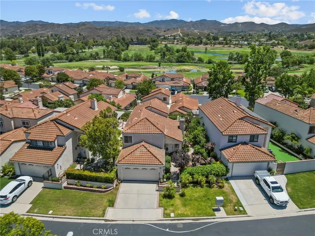 an aerial view of residential houses and outdoor space