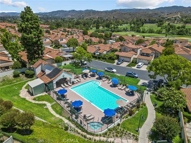 an aerial view of residential houses with outdoor space and parking