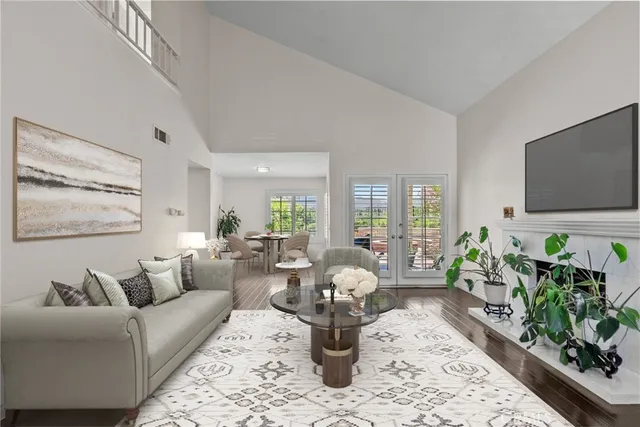 a living room with furniture potted plant and a flat screen tv