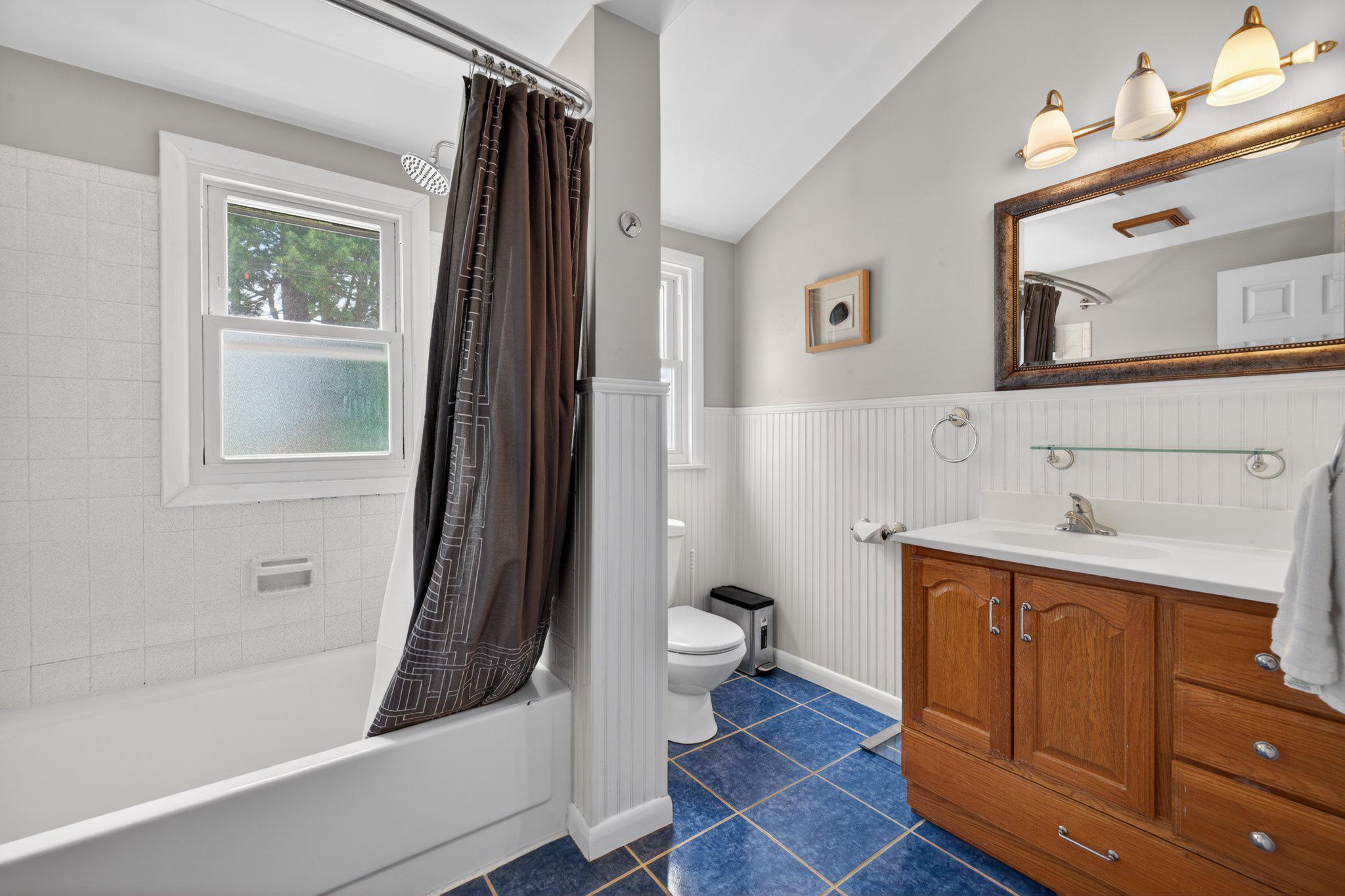 1002 Wilson Place Frederick, MD 21702 - Photo 18 of 30 a bathroom with a sink a toilet a mirror and shower