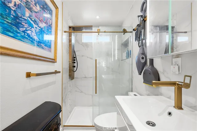 a bathroom with a sink a toilet and shower