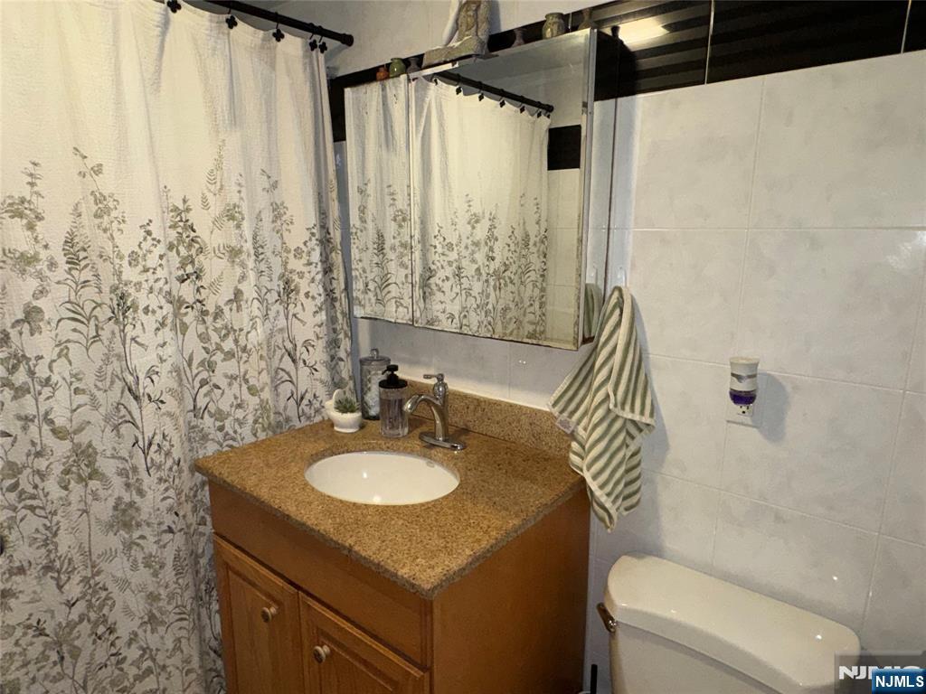 542 Prospect Place Lyndhurst, NJ 07071 - Photo 7 of 7 a bathroom with a sink toilet and shower