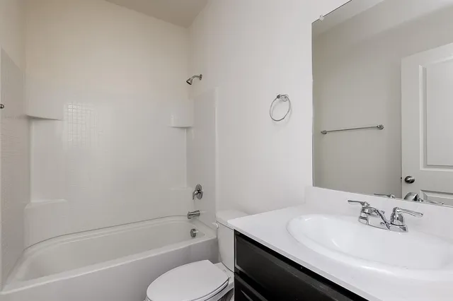 a bathroom with a sink toilet vanity and bathtub