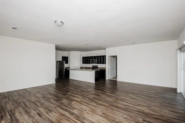 a view of kitchen with microwave and cabinets