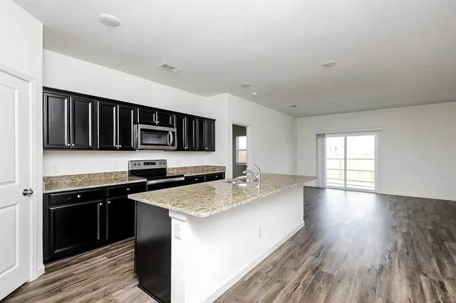a kitchen with stainless steel appliances granite countertop a stove and a sink