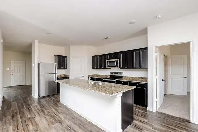 a kitchen with cabinets and steel stainless steel appliances
