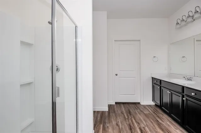 a view of a hallway with wooden floor