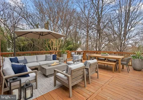 a view of a patio with wooden floor and outdoor seating