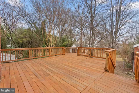 a view of deck with wooden floor and trees