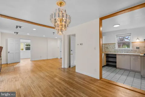 a view of a kitchen with a sink and a refrigerator