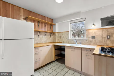 a kitchen with stainless steel appliances a sink and a refrigerator