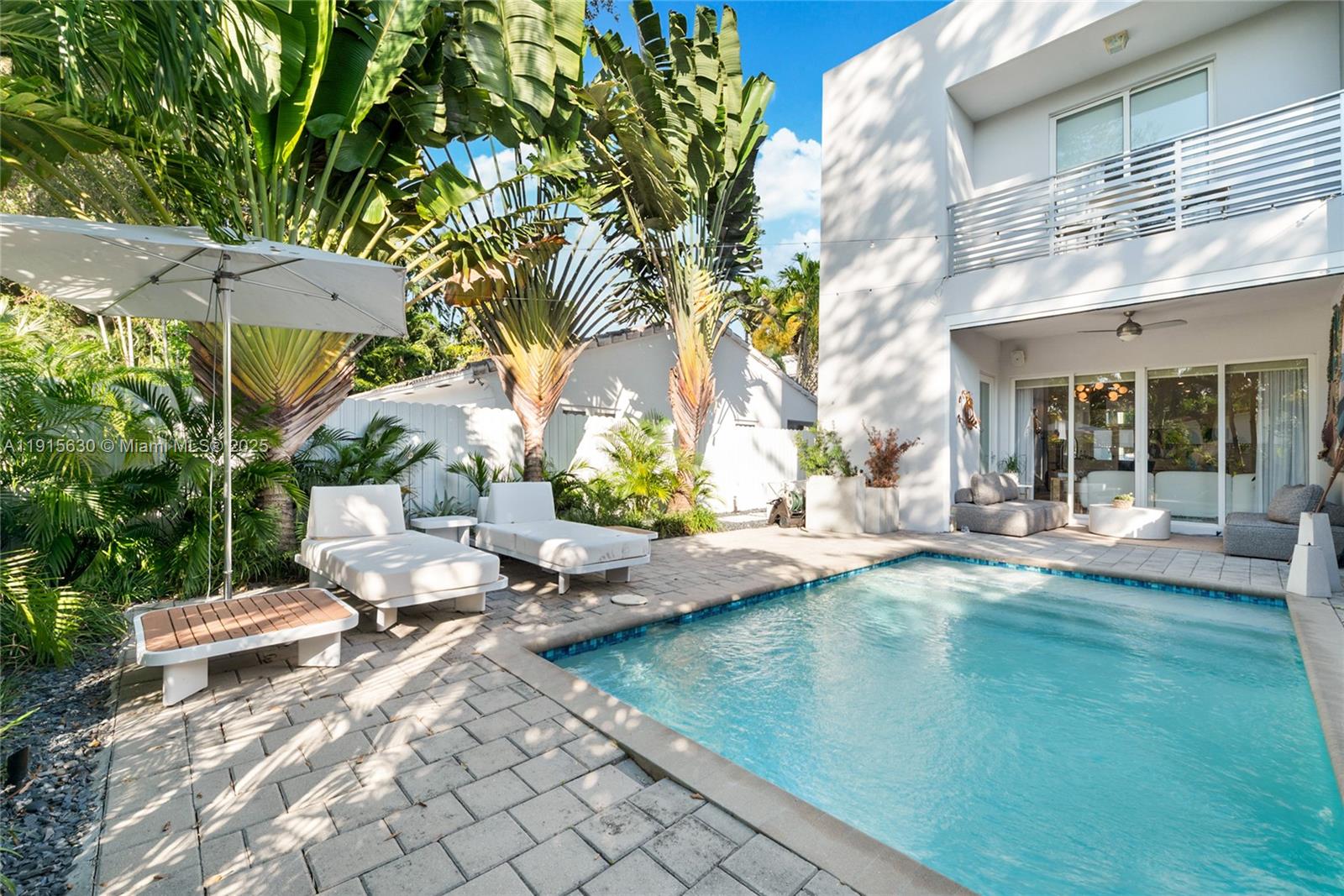 2410 Southwest 16th Avenue Miami, FL 33145 - Photo 18 of 25 a view of pool with lawn chairs under an umbrella