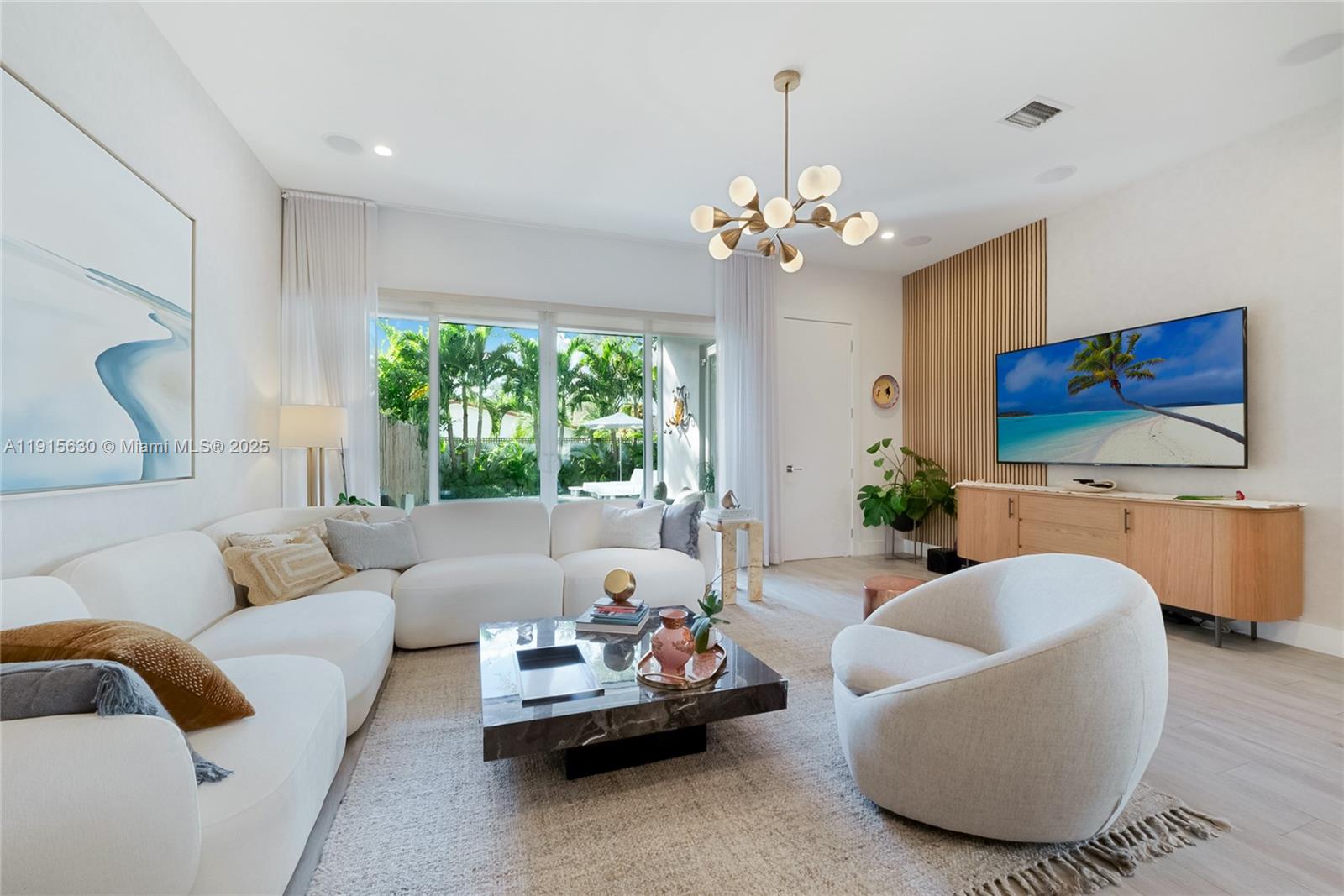 2410 Southwest 16th Avenue Miami, FL 33145 - Photo 3 of 25 a living room with furniture chandelier and a flat screen tv