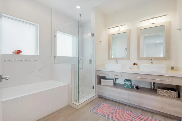 a spacious bathroom with sinks mirror and a bathtub