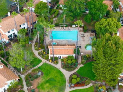 an aerial view of a house with a yard and potted plants