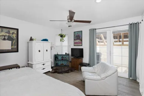 a bedroom with furniture and a flat screen tv