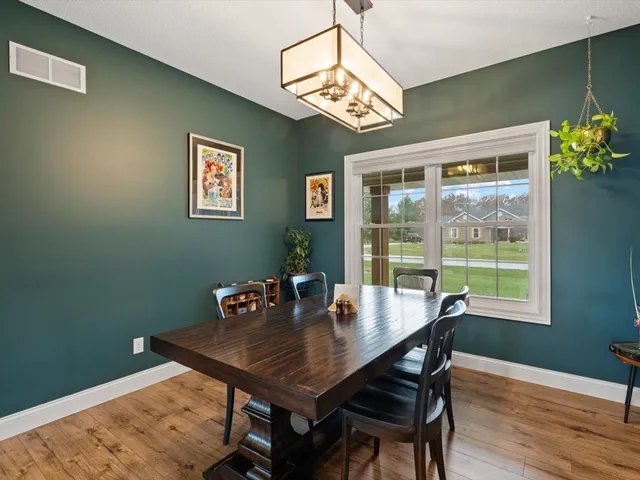 a bedroom with a bed a window and a flat screen television