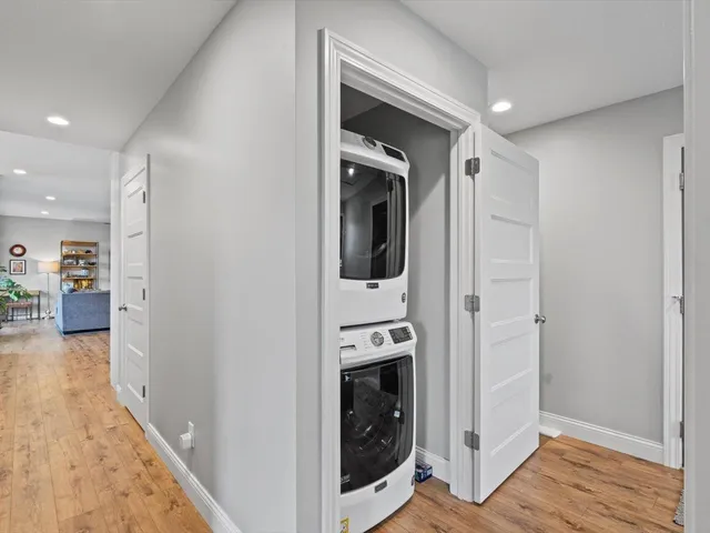 a bedroom with a bed a table and potted plants