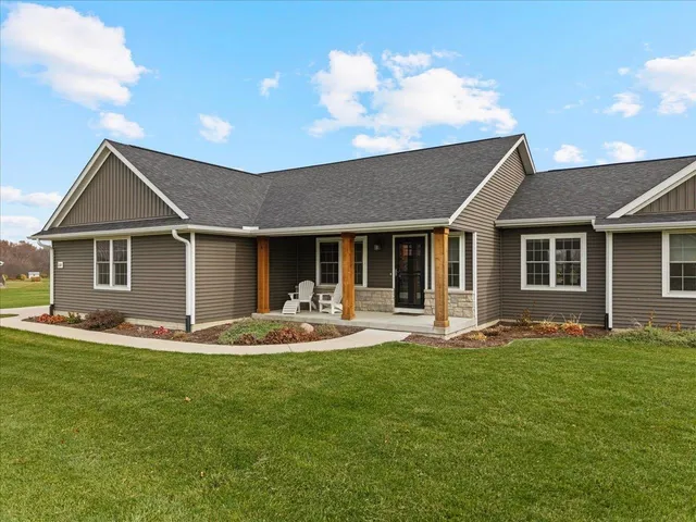 a front view of a house with a garden and patio